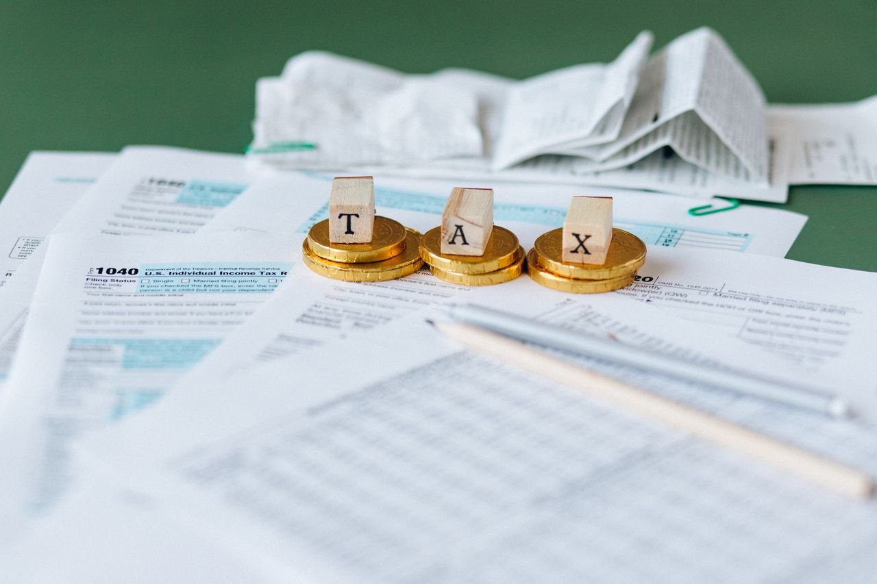 Mastering the First Impression: Your intriguing post title goes here Close-up of tax forms, receipts, and coins symbolizing financial accounting and taxes.